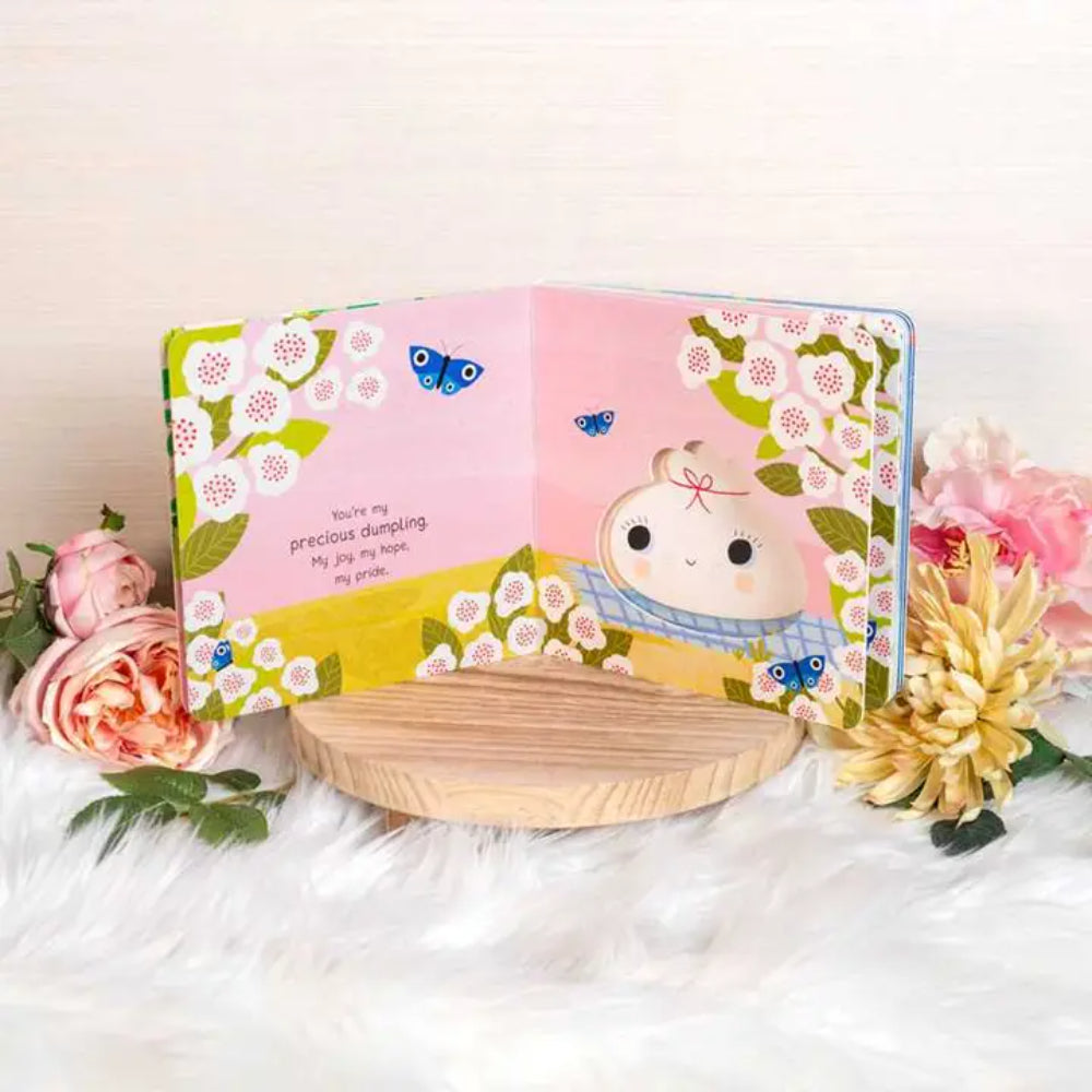 Children's book with a cartoon character on a white surface with flowers