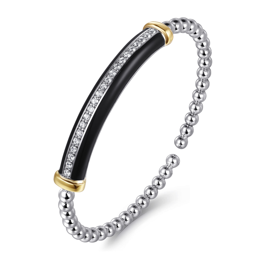 Bangle with black center, gold edge, and silver beads on a white background