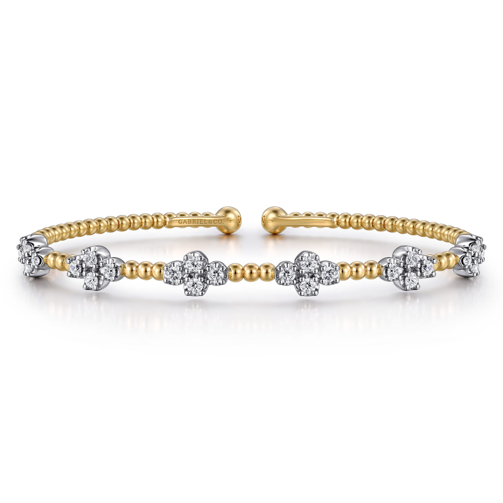 gold beaded bangle bracelet with clear stones on white background