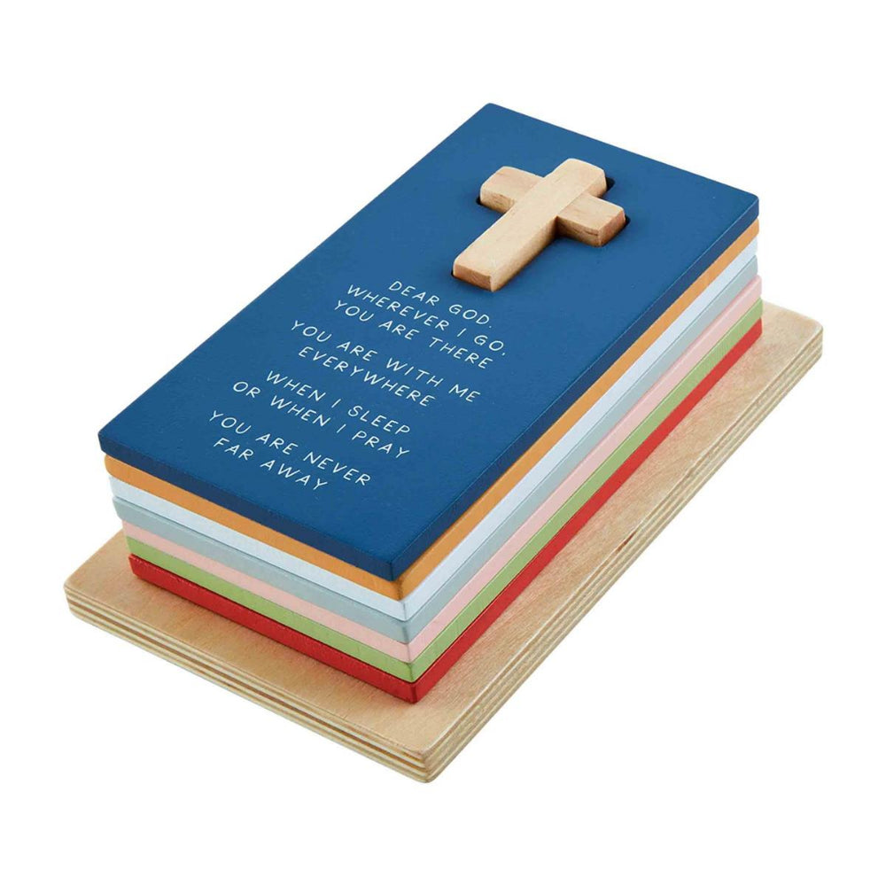 A stacked colorful wooden puzzle set designed to stack on a cross post, featuring pieces with prayers printed on them on a white backround.