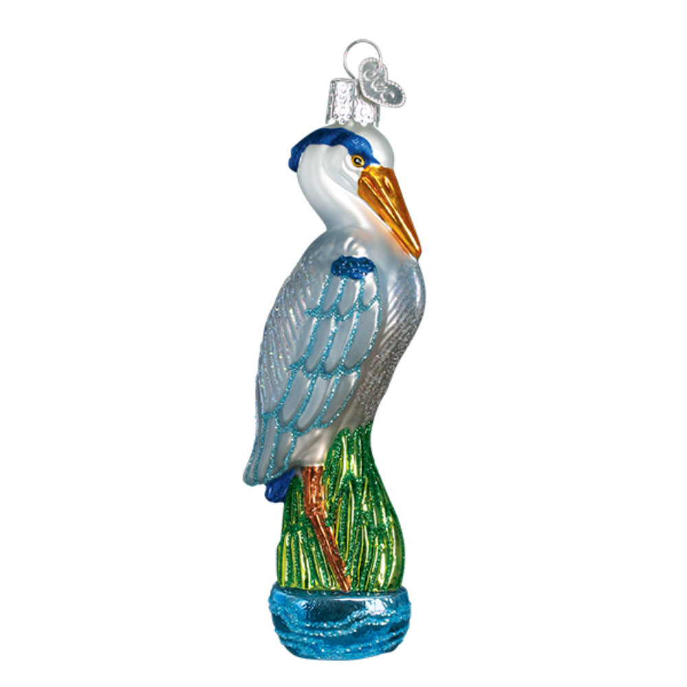 A christmas ornament of a Blue Heron on a white backround. 