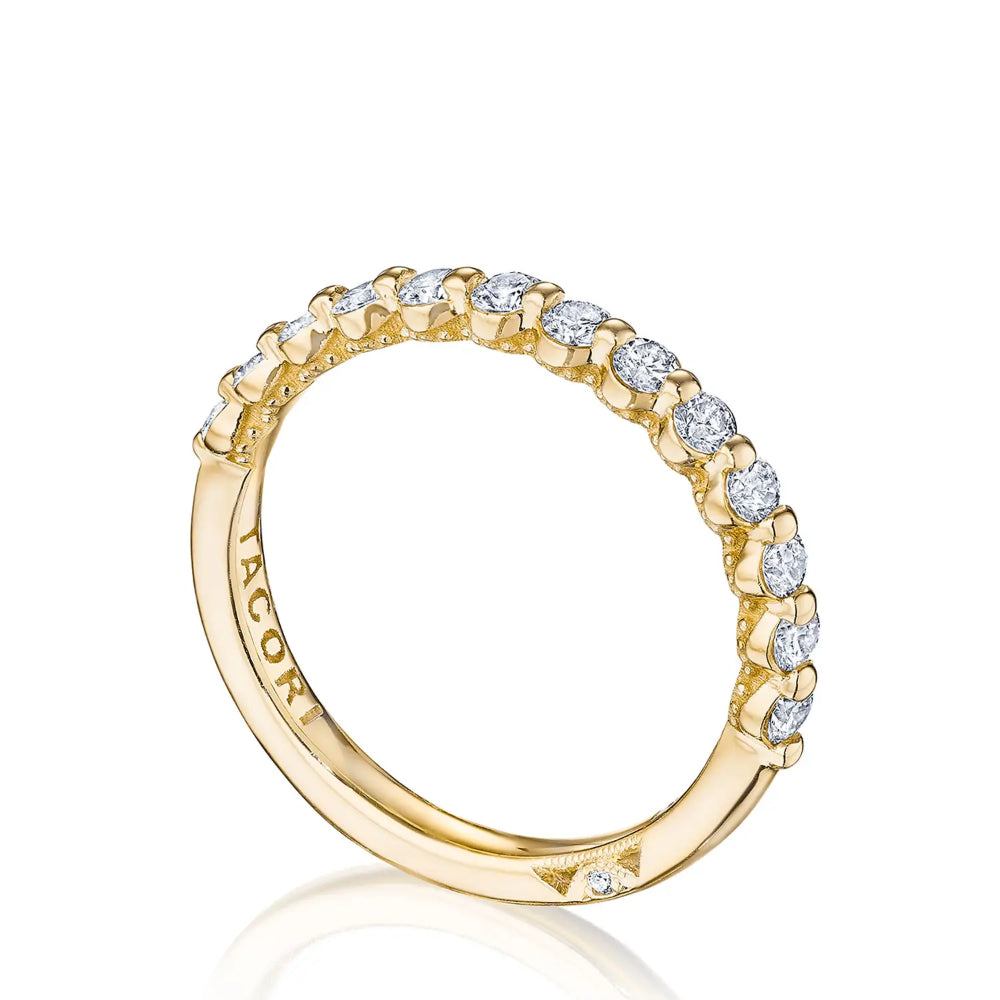 A two-prong diamond band ring with round and logo diamonds set in 18k yellow gold.