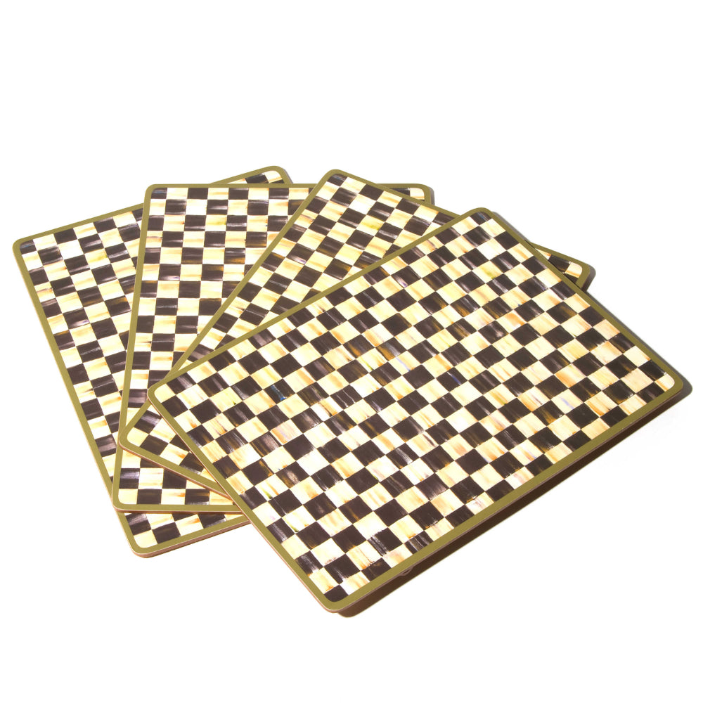 Set of four black and white checkered placemats on a white background