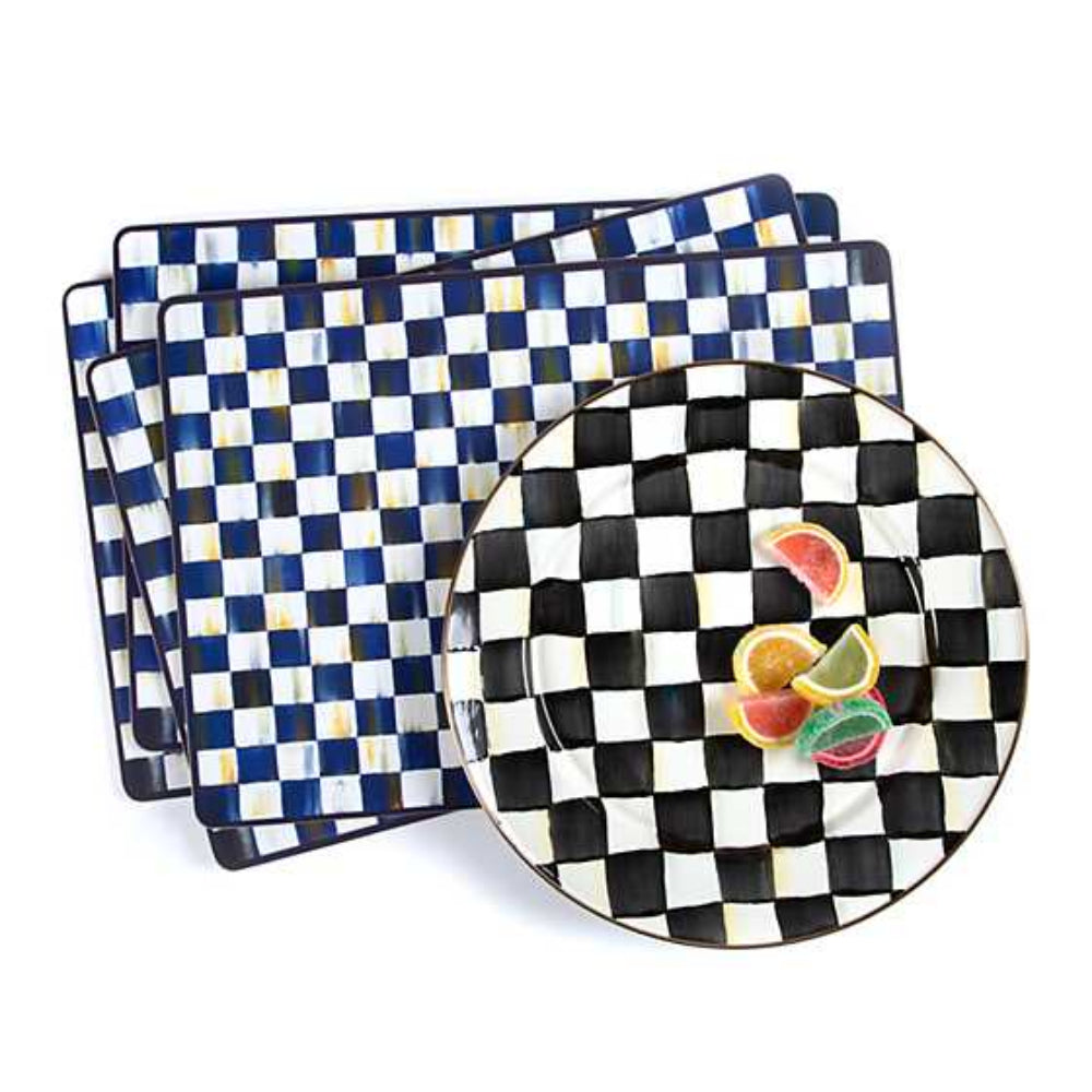 MacKenzie-Childs royal check cork back placemats and a courtly check patterned plate with colorful fruit on a white backround 