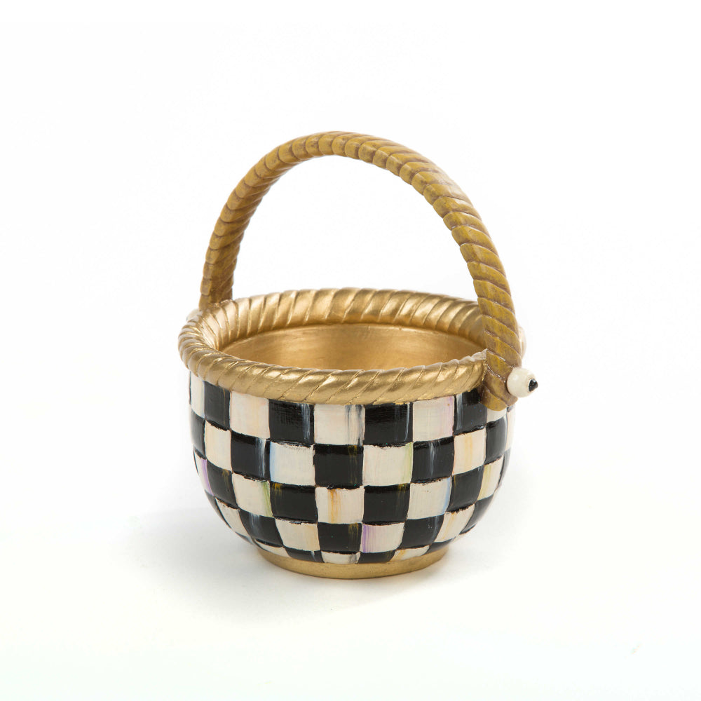 A small, black and white checkered basket with a gold-colored rim and handle.