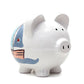 A white ceramic piggy bank with a nautical design, including a sailboat illustration in blue and brown colors on the side.