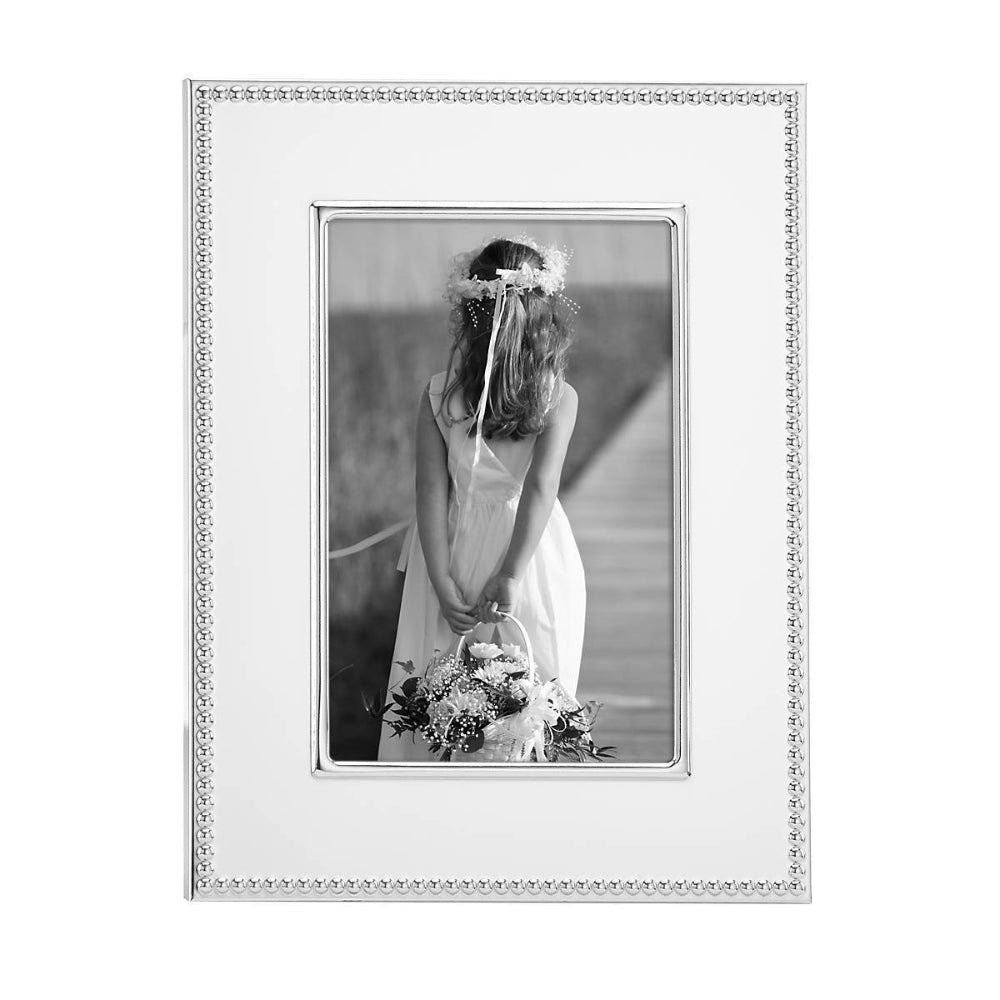 4x6 Lyndon Silverplate Frame with with a decative silver egde with black and white photo of a woman holding flowers on a white background.