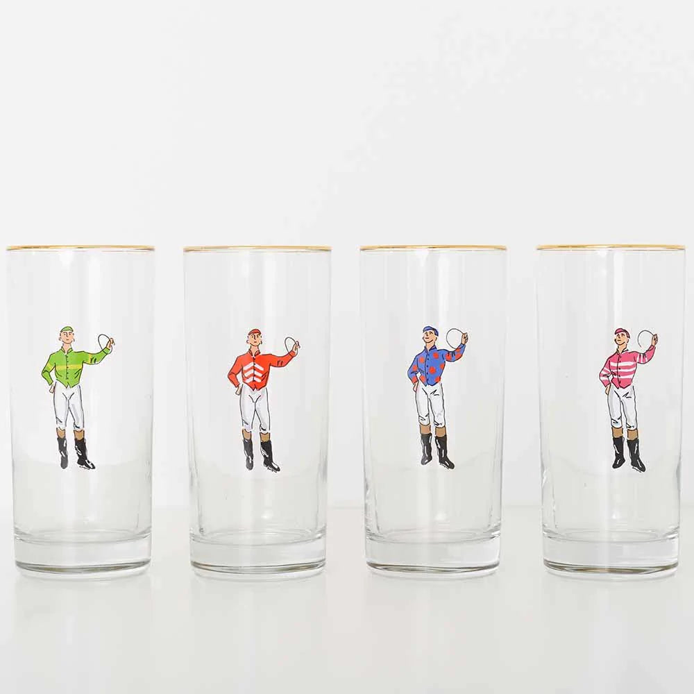 A set of four clear highball glasses, each with a colorful illustration of a jockey wearing different colored silks, and a gold rim at the top.