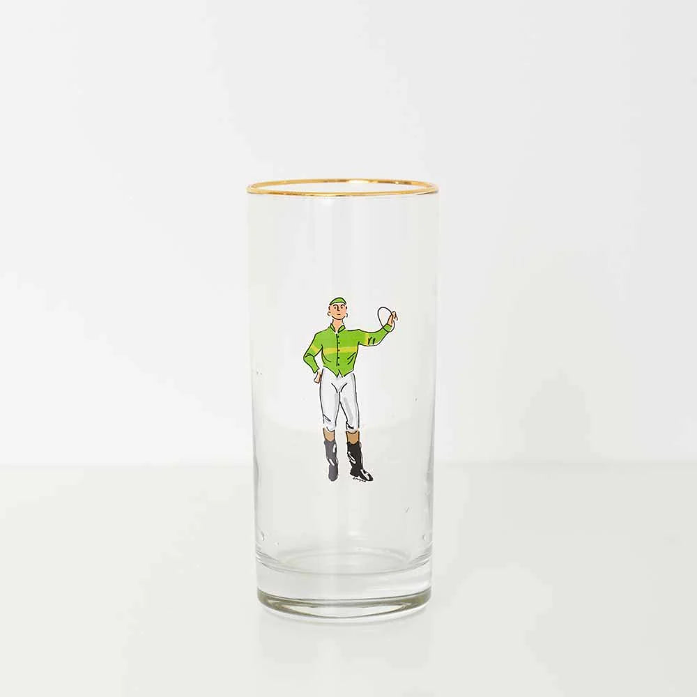 A bourbon glass with a green jockey on a white background. 
