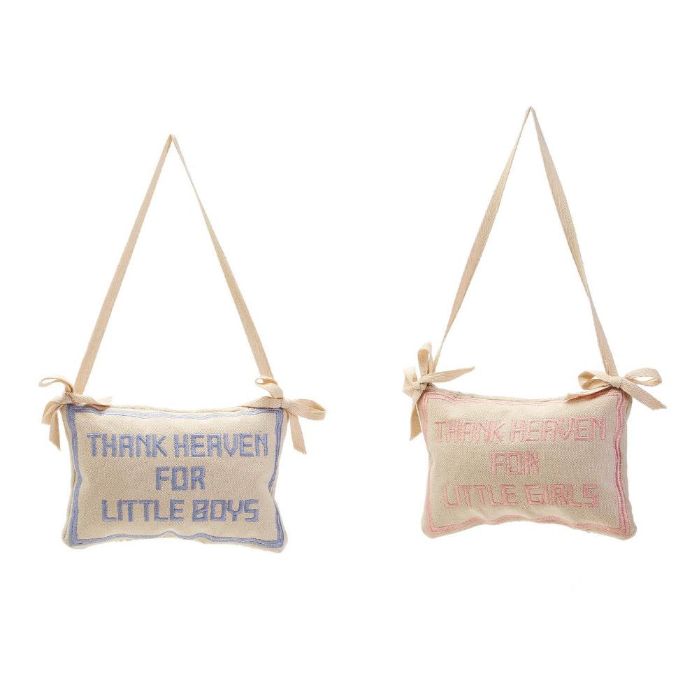 Two beige embroidered pillows with the phrases 'Thank Heaven for Little Boys' and 'Thank Heaven for Little Girls', in blue and pink colors respectively, on a white background.