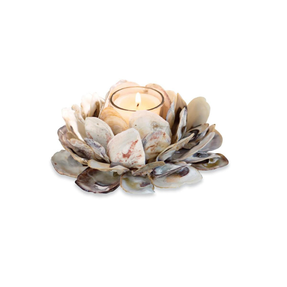 Decorative candle holder made of oyster shells on a white background.