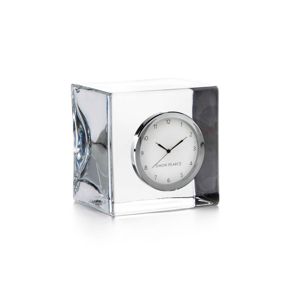 Clear glass clock with Simo Pearce on a white background.