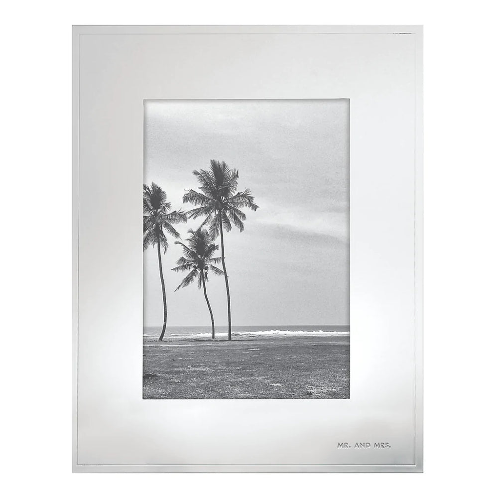 Silver 5x7 silver plated and stamped steel frame with a black and white photo of a tropical beach scane with palm trees on a white backround.