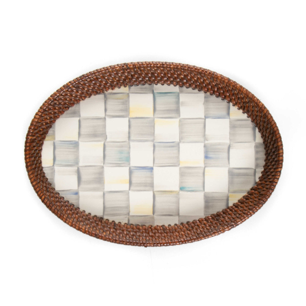 Top veiw of a small  round woven tray with a brown rim on a sterling grey checkered pattern bottom on a white background