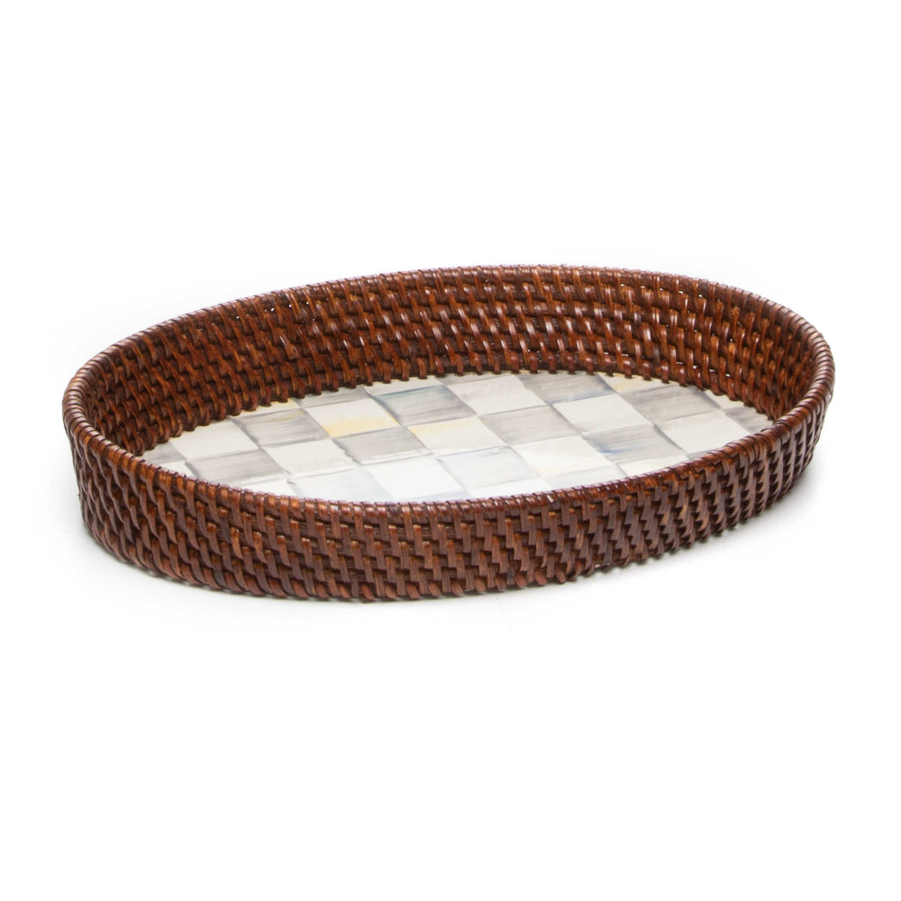 Side veiw of a small round woven tray with a brown rim on a sterling grey checkered pattern bottom on a white background