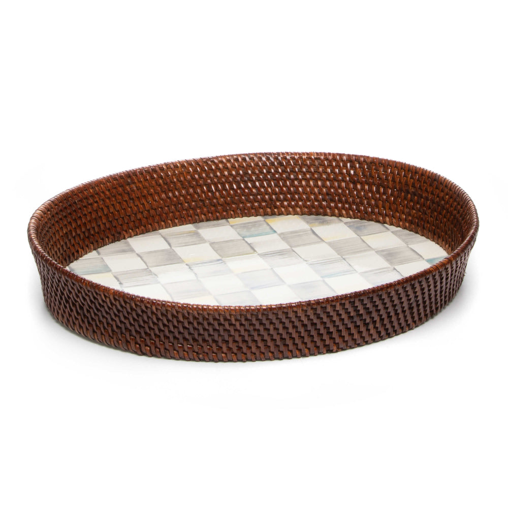 Side veiw of a large round woven tray with a brown rim on a sterling grey checkered pattern bottom on a white background