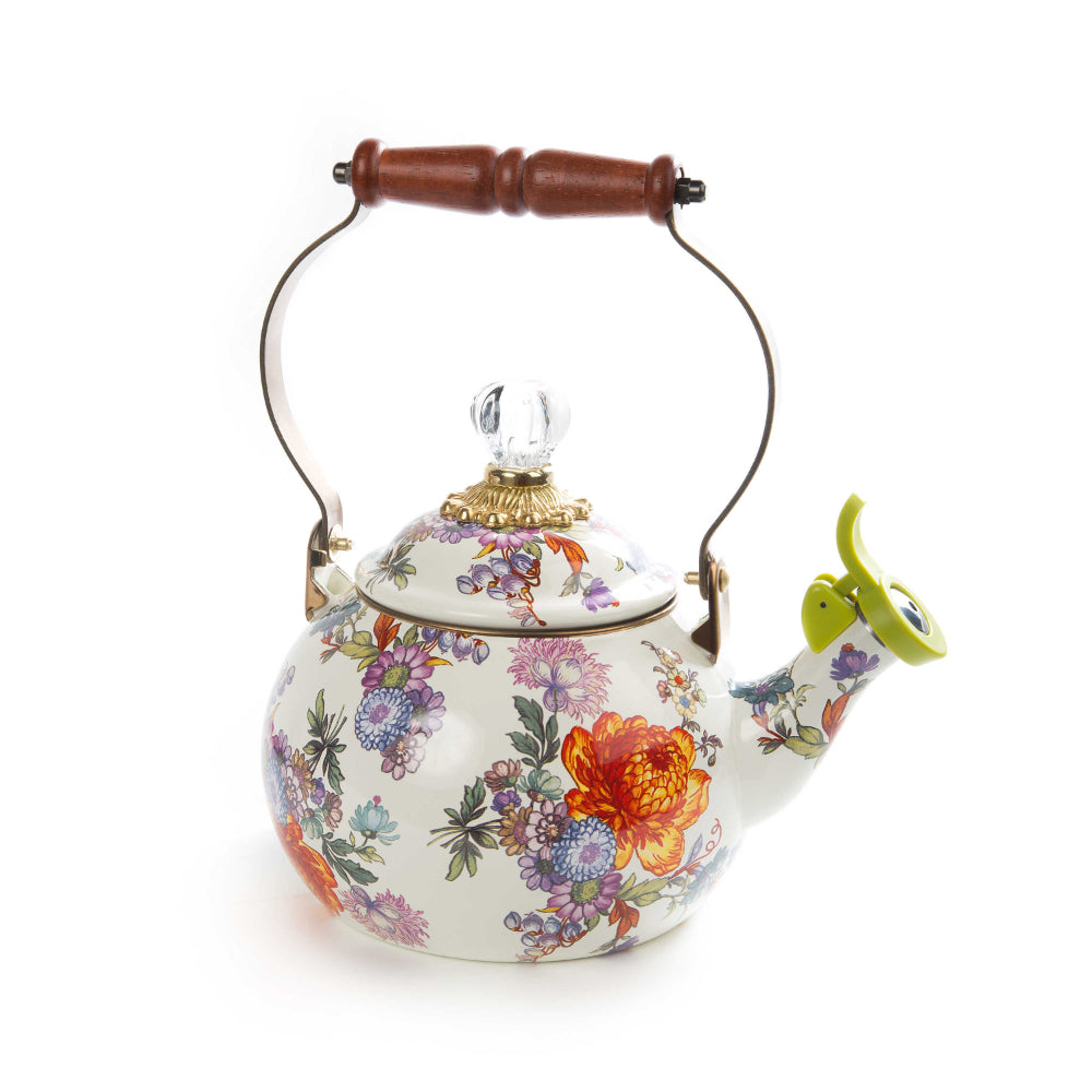 Decorative white teapot with colorful floral patterns on a white background