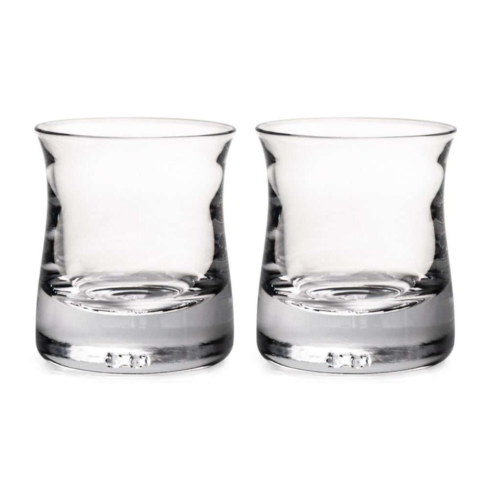 A set of two clear, curved glass whiskey glasses with a smooth surface and no visible contents.