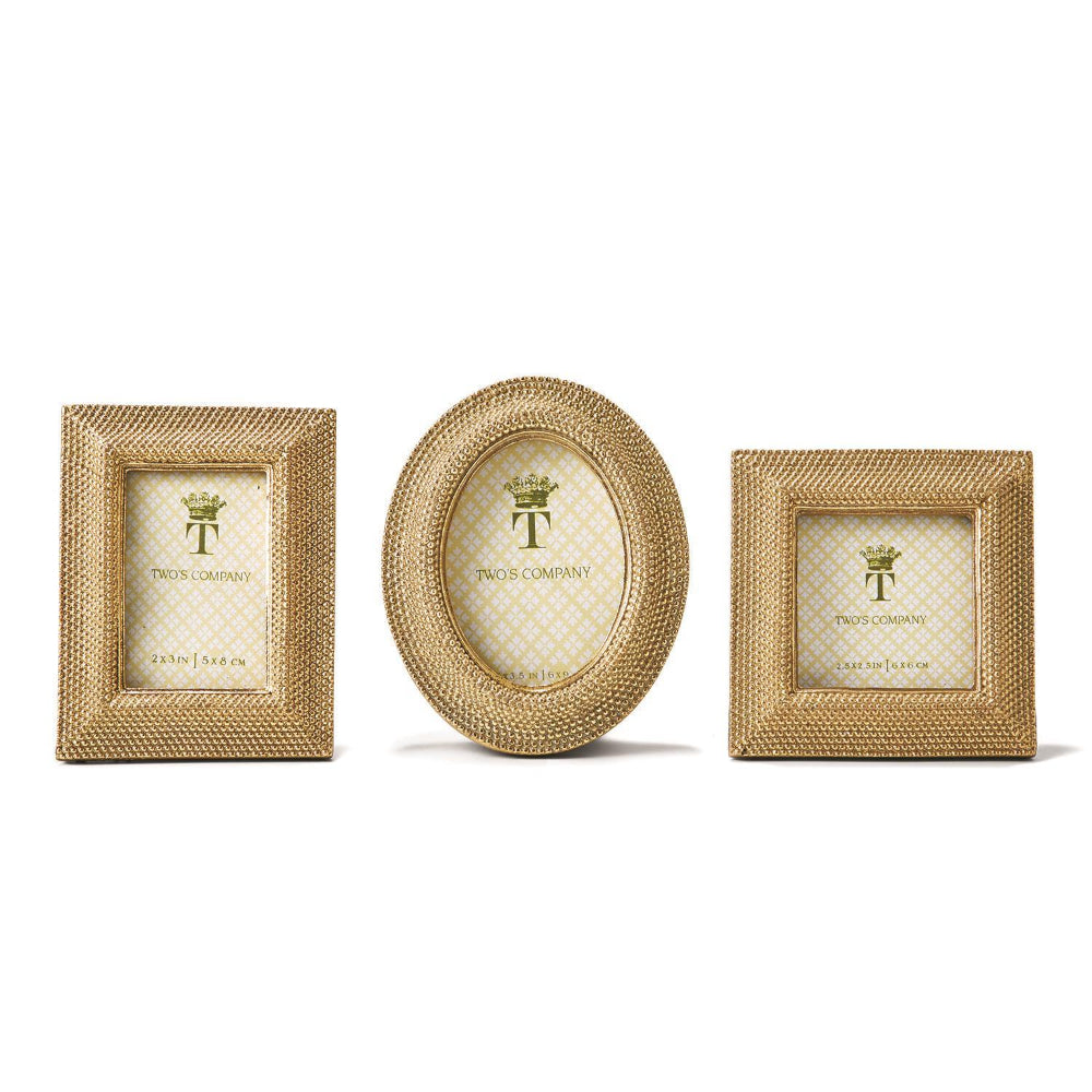 Three gold photo frames and three shapes, oval,rectangle & square  with 'TWO'S COMPANY' branding on a white background.