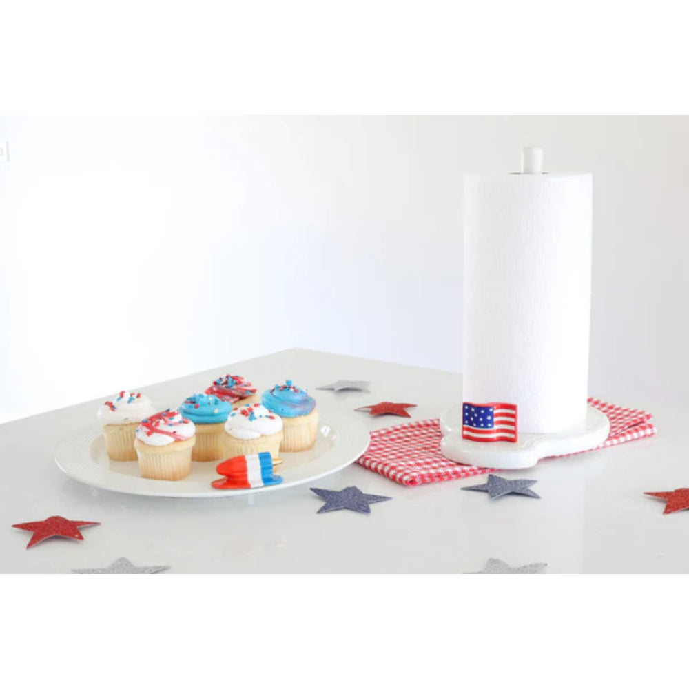 Small rectangular mini decor piece with American flag design on a gray table with fourth of july cupcakes on a plate. 