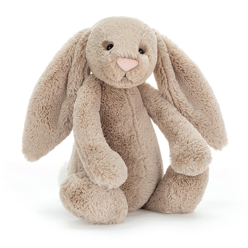 A large size  beige plush toy in the shape of a bunny with long floppy ears, a small pink nose, and a soft fur texture on a white backround 