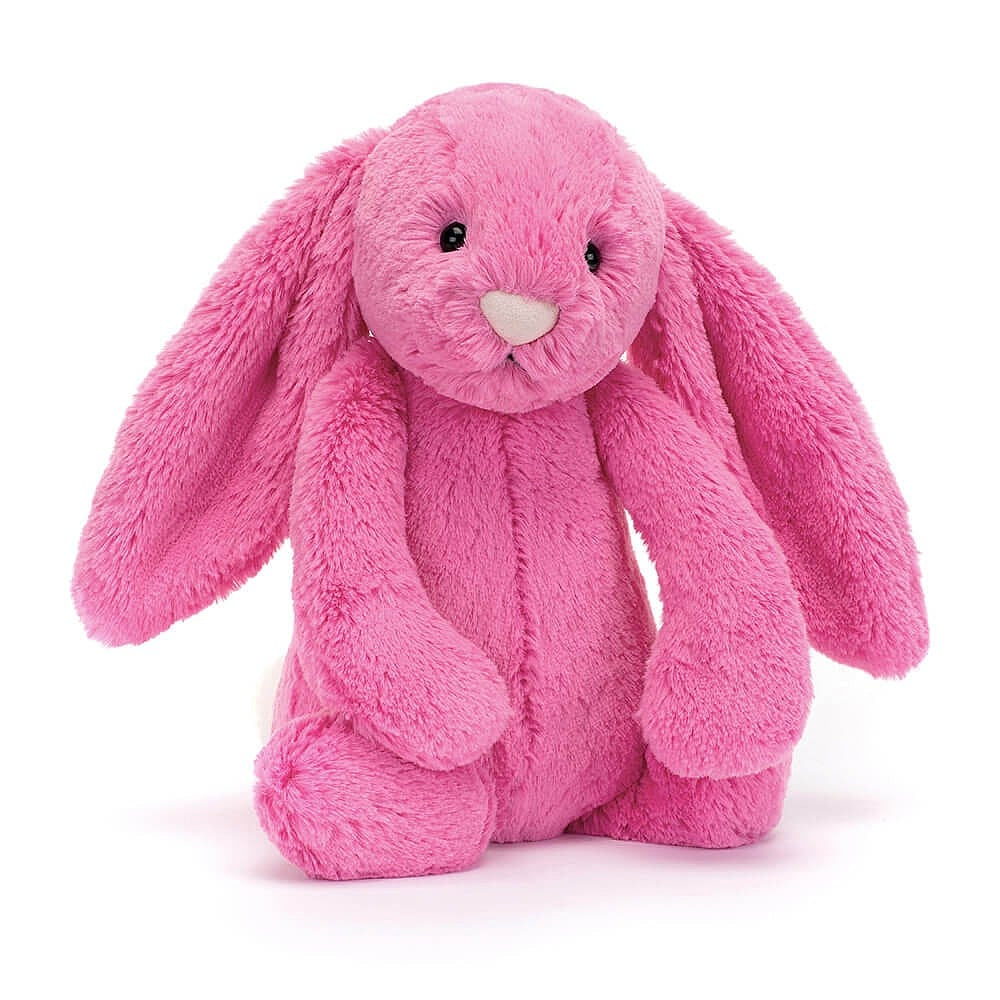 A plush hot pink bunny toy with a soft texture on a white backround.