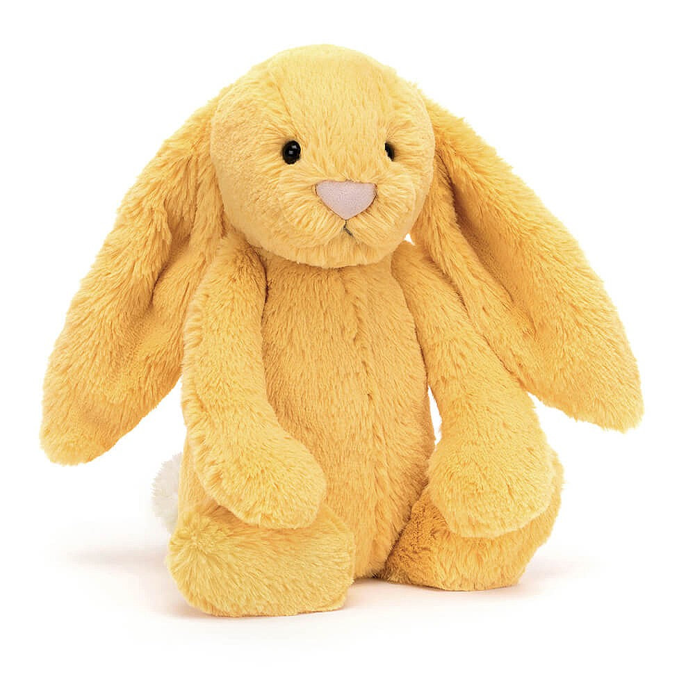 A plush sunshine yellow bunny toy with a soft texture on a white backround.
