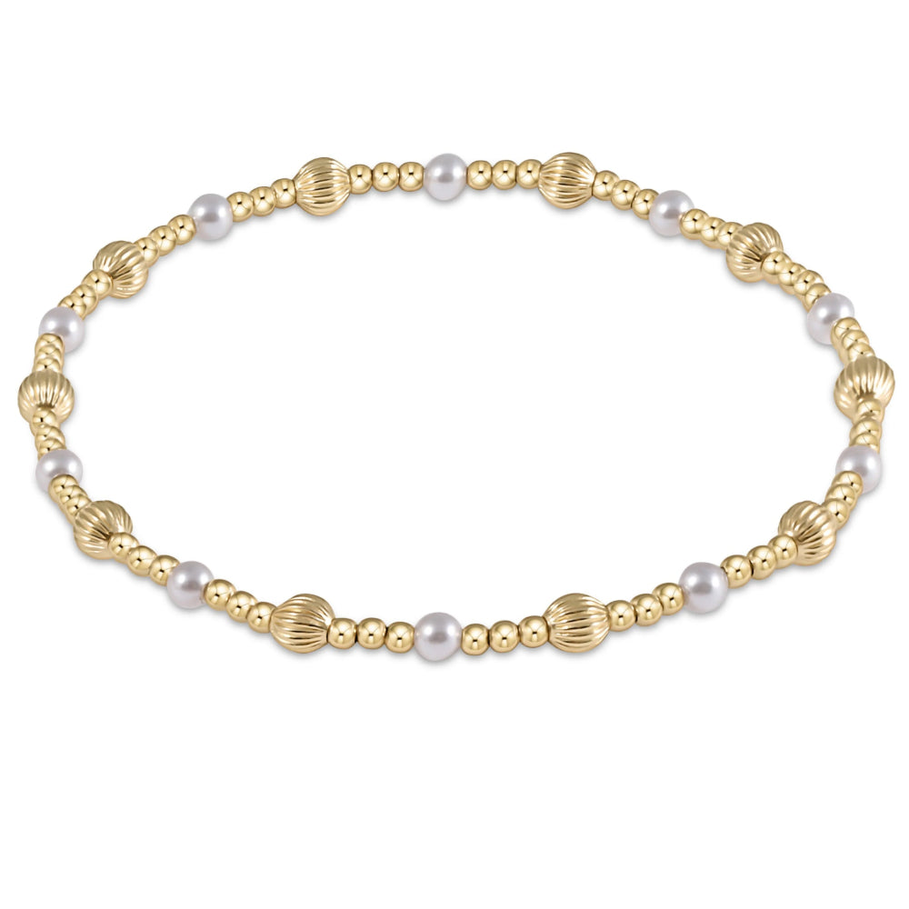 Gold and pearl bracelet on a white background
