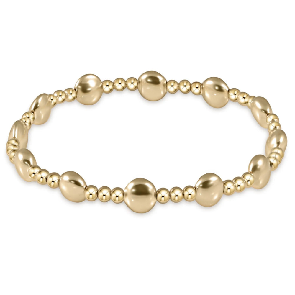 Gold beaded bracelet on a white background