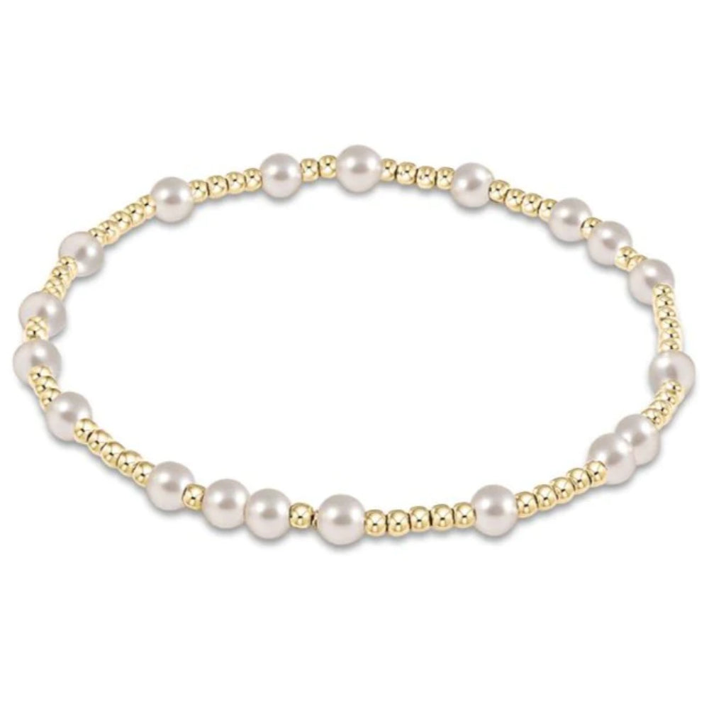 Pearl bracelet with gold accents on a white background