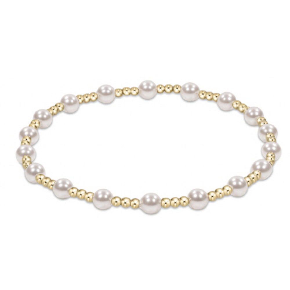 Pearl bracelet with gold accents on a white background