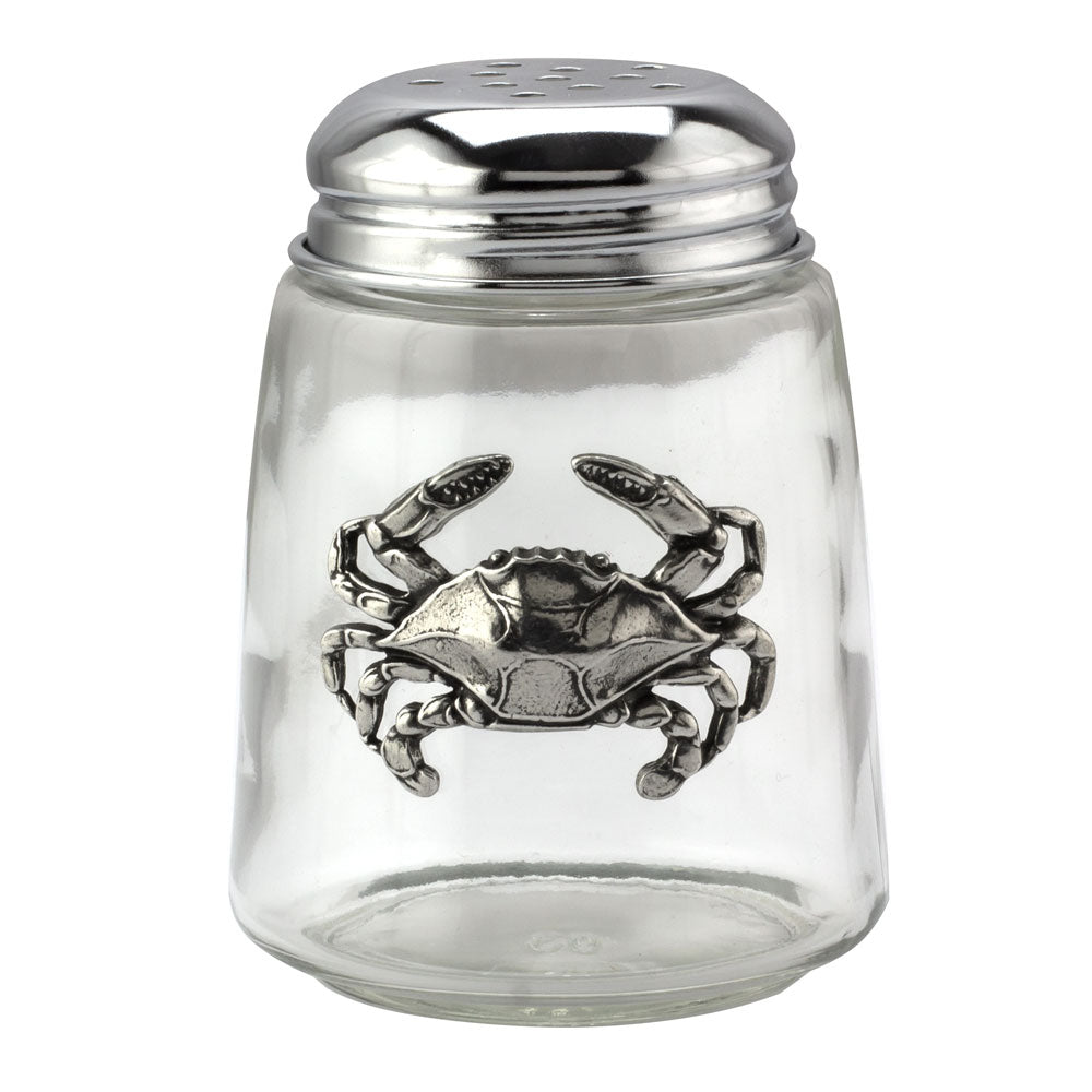 Clear glass jar with silver crab embellishment on a white background.