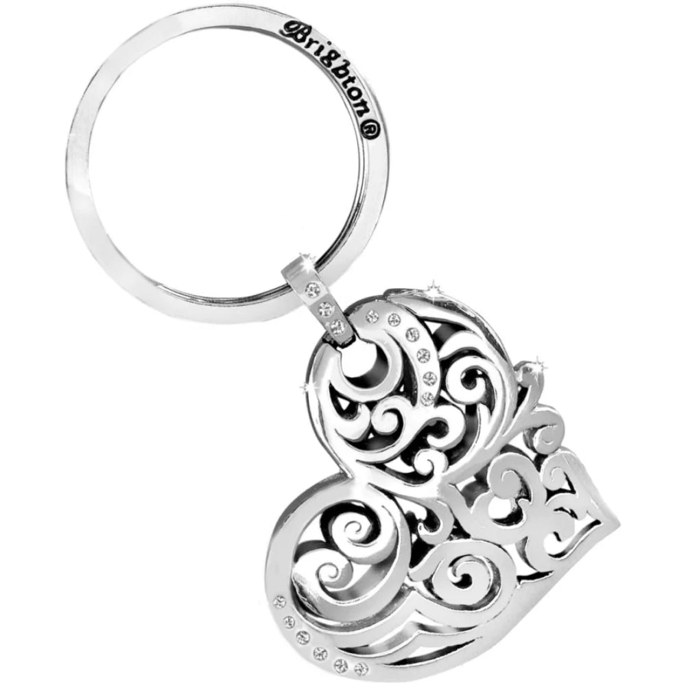 Silver keychain with intricate designs on a white background