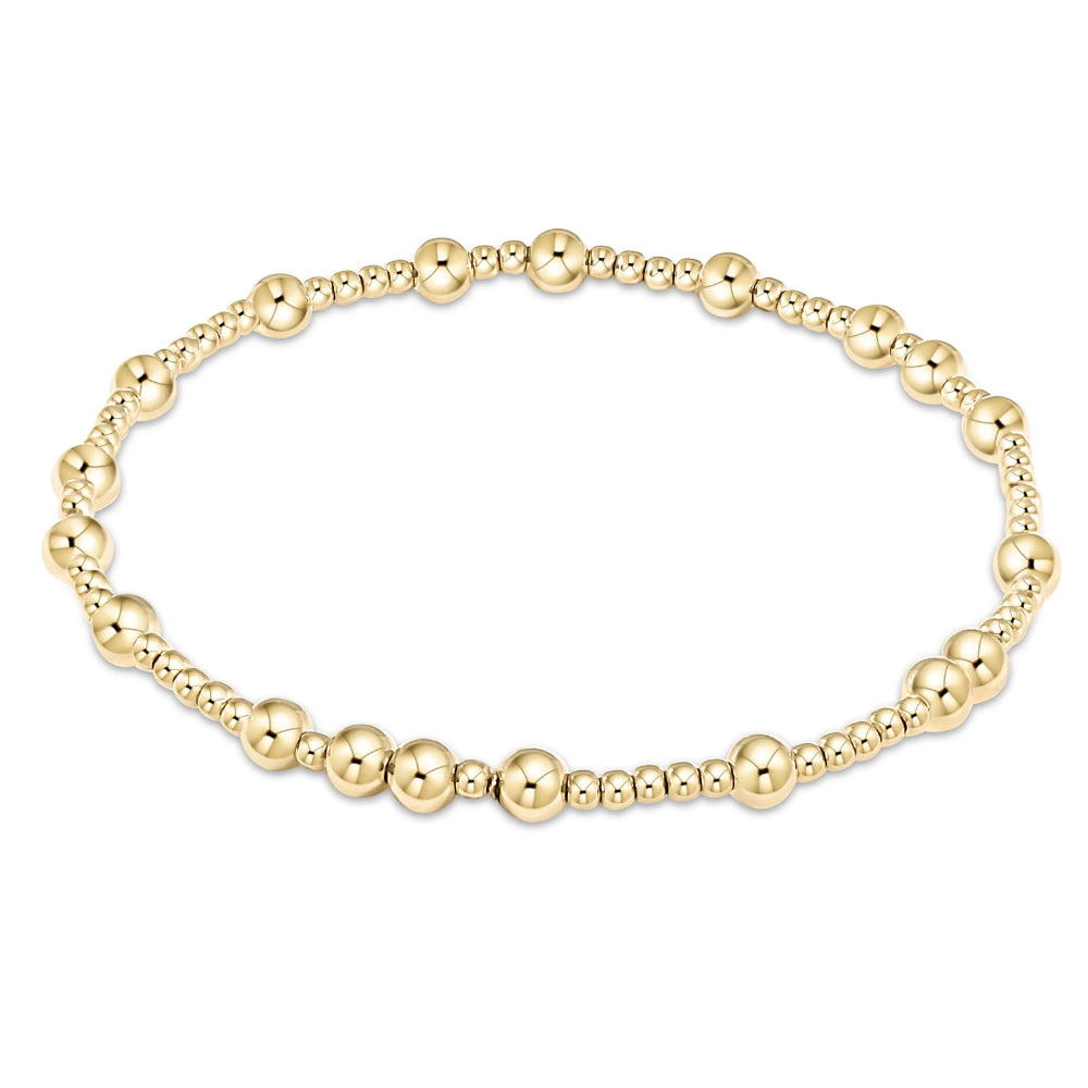 Gold beaded bracelet on a white background