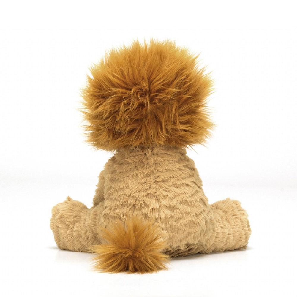 A photo of the back of a medium-sized plush toy lion with beige fur and an amber mane, sitting upright on a white backround 