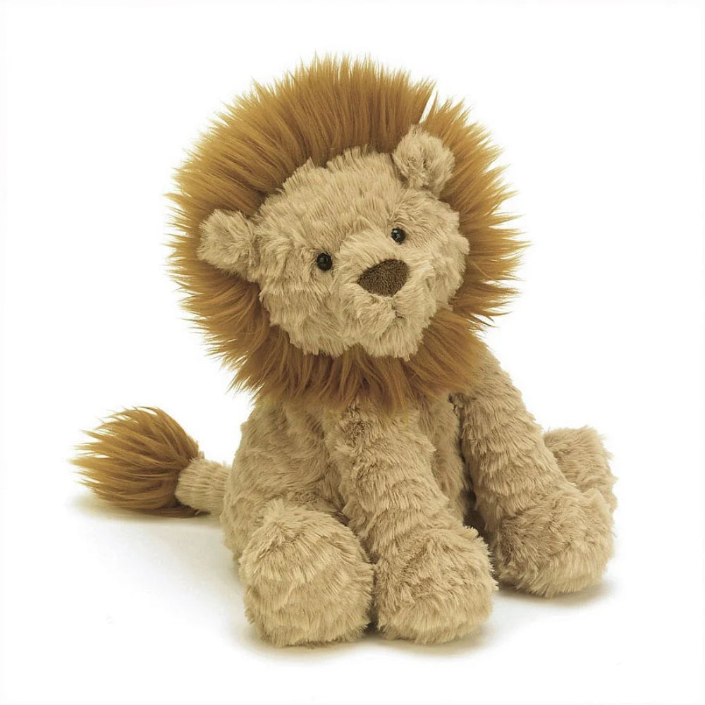 A medium-sized plush toy lion with beige fur and an amber mane, sitting upright on a white backround 