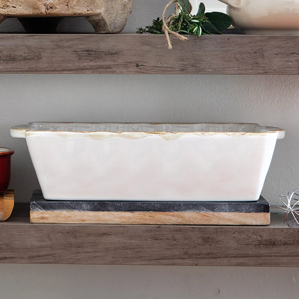  A photo of vietri italian medium rectangular white colored baker with a white interior on a shelf on a multi-colored backround 