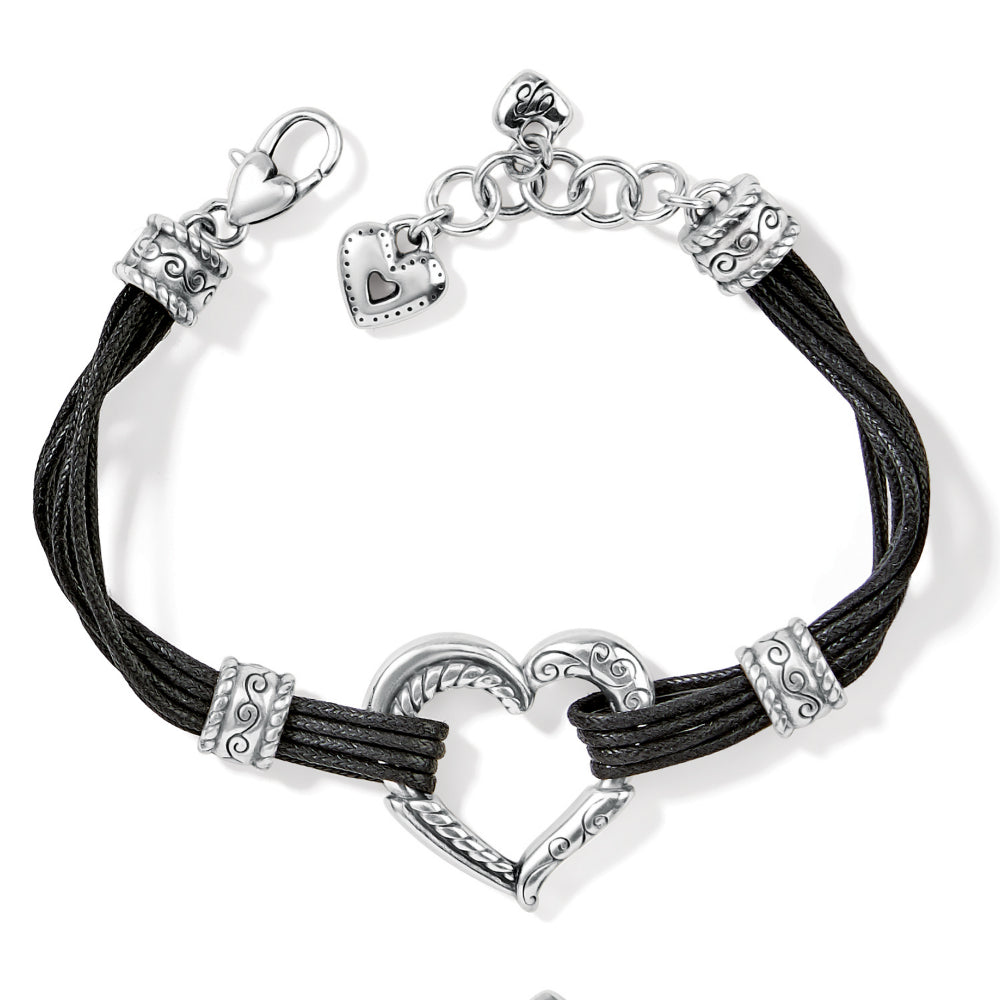 Black cord bracelet with silver heart-shaped clasp on a white background