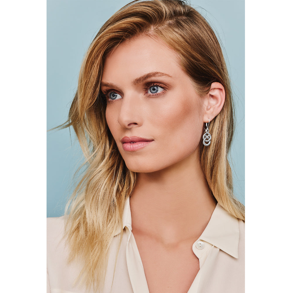 Silver earrings on model