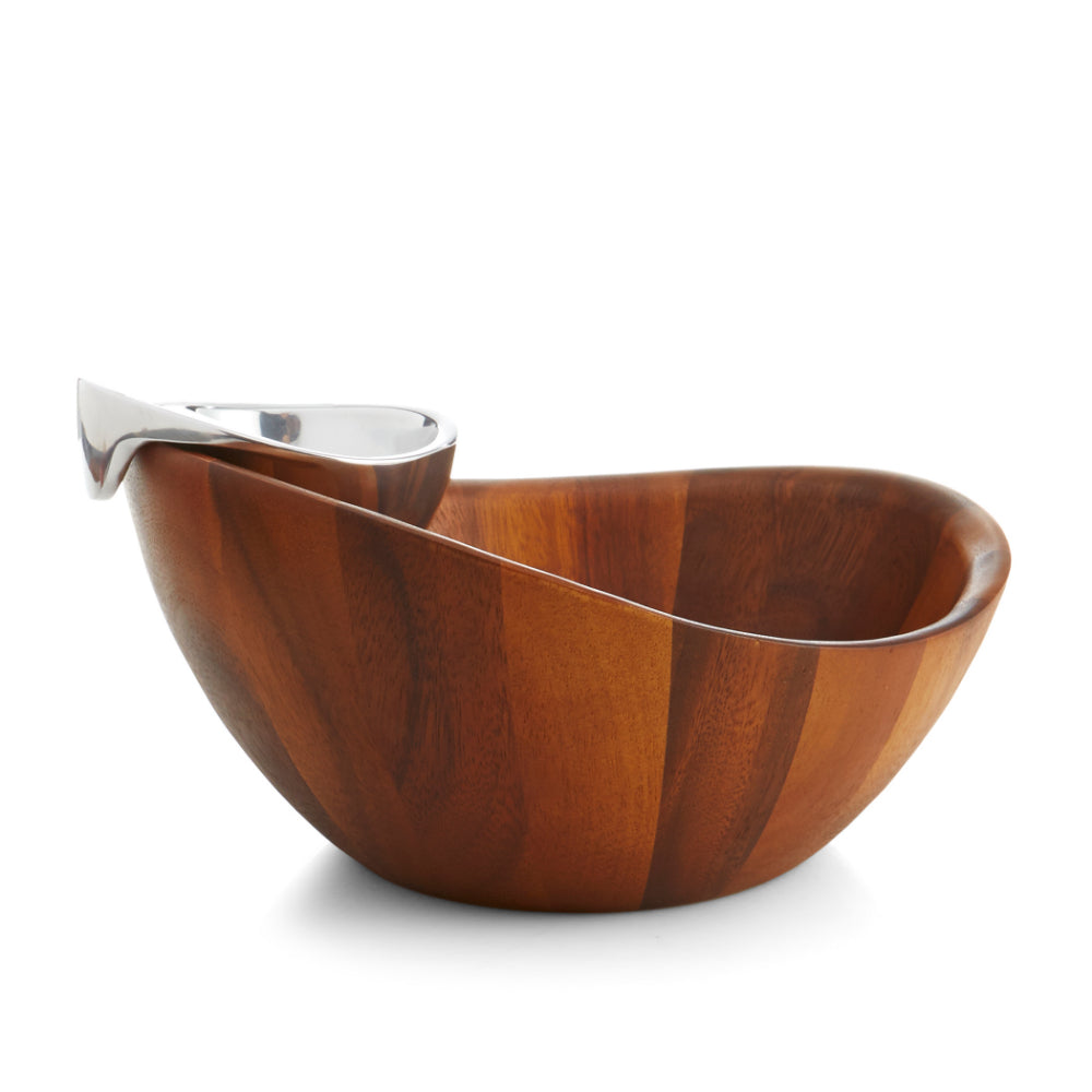 A side photo of a two-piece Nambé Harmony Chip & Dip serving bowl set, with a larger bowl made of Acacia wood and a smaller alloy bowl inside for serving dips on a white backround.