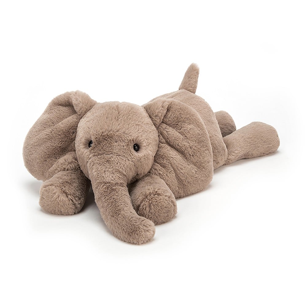 A medium size plush toy elephant with soft grey-brown fur, big black eyes, and large ears on a white backround 